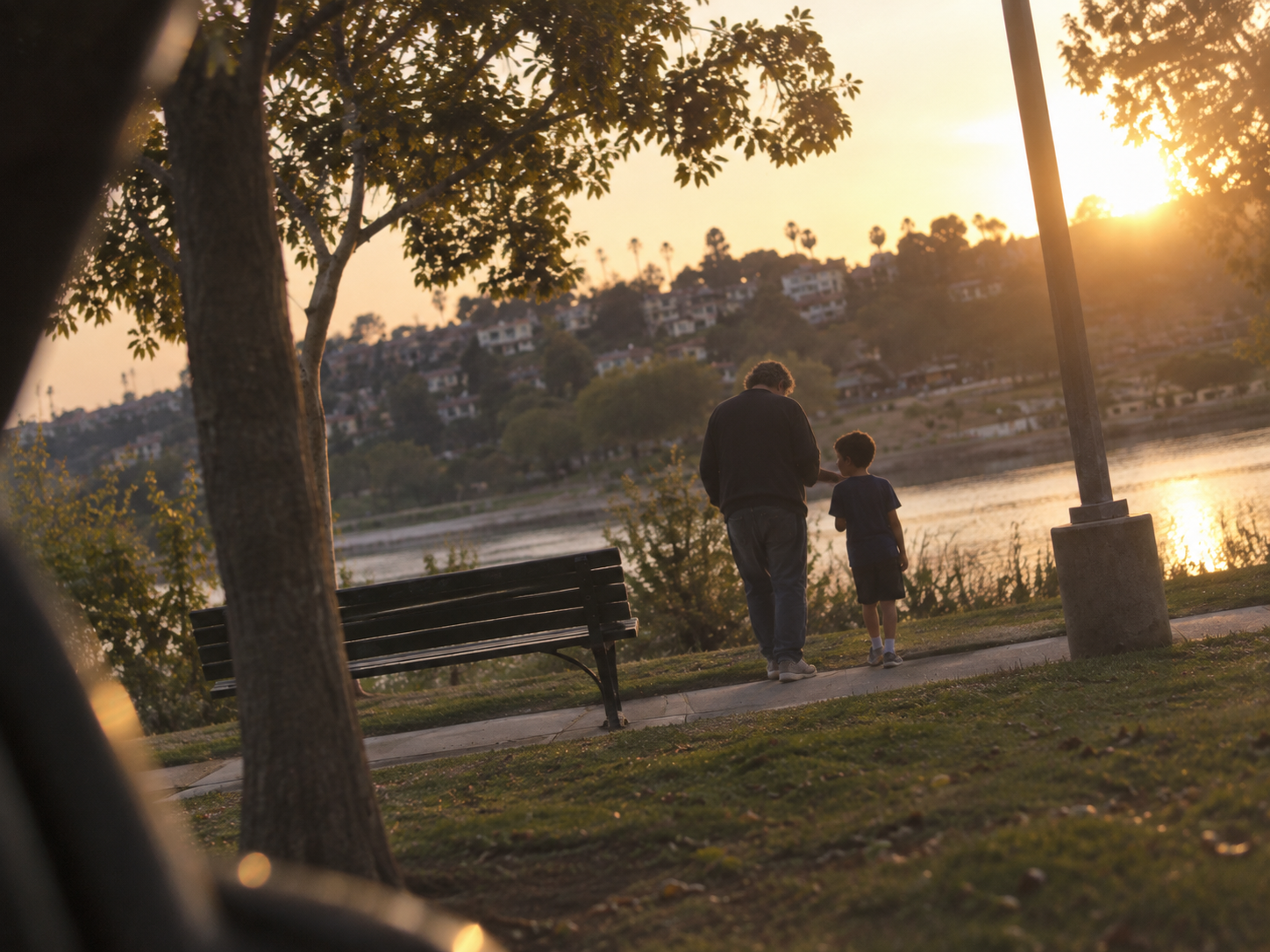 Illustrative dramatization of a father and child sharing a quiet moment by the water.